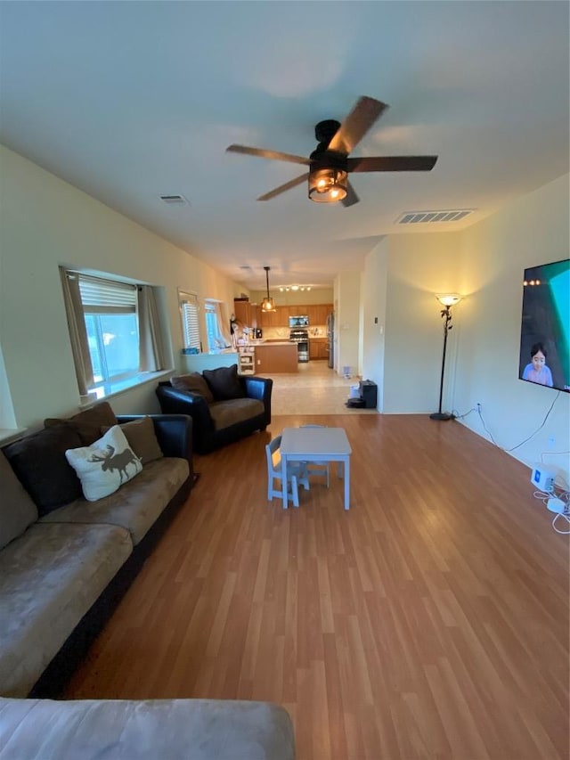 14501 Dreamtime Ln, Pflugerville, TX 78660 - living area featuring a ceiling fan and light wood-type flooring