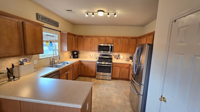 14501 Dreamtime Ln, Pflugerville, TX 78660 - kitchen featuring stainless steel appliances, a sink, tasteful backsplash, and light countertops