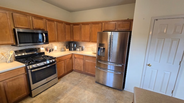 14501 Dreamtime Ln, Pflugerville, TX 78660 - kitchen featuring stainless steel appliances, decorative backsplash, light countertops, and brown cabinets