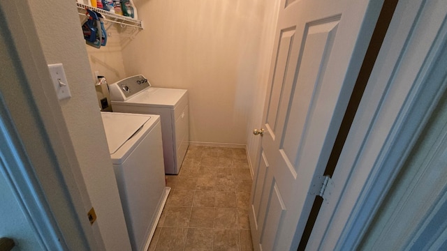 14501 Dreamtime Ln, Pflugerville, TX 78660 - laundry area featuring washing machine and clothes dryer, tile patterned floors, and baseboards