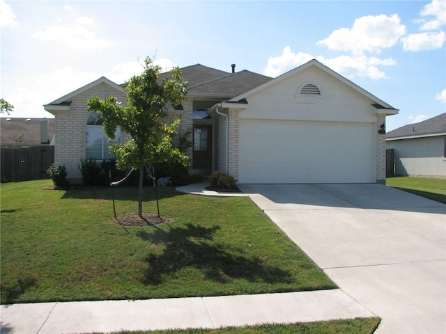 123 Bayliss St, Hutto, TX 78634 - single story home featuring a garage, concrete driveway, and brick siding