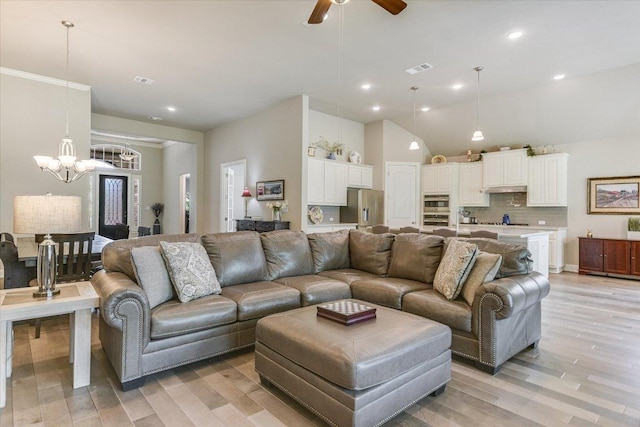 3221 Venezia Vw, Leander, TX 78641 - living room with a chandelier, light wood-style floors, ceiling fan, lofted ceiling, and recessed lighting
