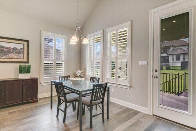 3221 Venezia Vw, Leander, TX 78641 - dining room featuring light wood-style floors, a chandelier, and lofted ceiling