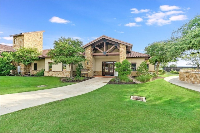 3221 Venezia Vw, Leander, TX 78641 - mediterranean / spanish house featuring french doors, a tiled roof, stone siding, a front yard, and stucco siding