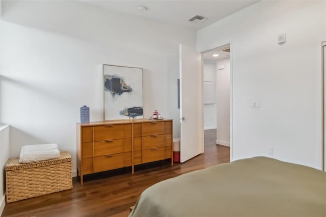 1322 E 12th St Unit 306, Austin, TX 78702 - bedroom featuring dark wood-style flooring
