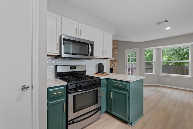 5902 Shreveport Dr, Austin, TX 78727 - kitchen featuring stainless steel appliances, green cabinetry, a peninsula, white cabinetry, and light countertops