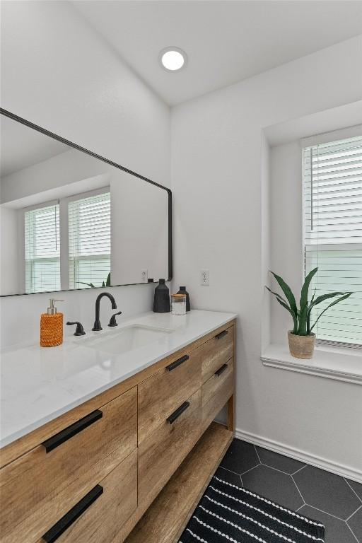 5902 Shreveport Dr, Austin, TX 78727 - bathroom featuring vanity, tile patterned flooring, and baseboards