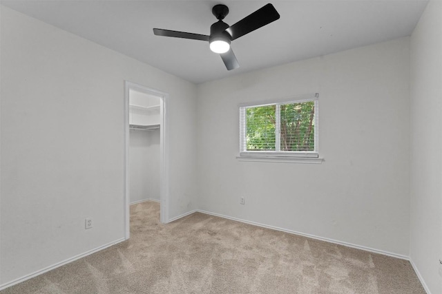 5902 Shreveport Dr, Austin, TX 78727 - unfurnished bedroom with carpet, a walk in closet, baseboards, a closet, and a ceiling fan