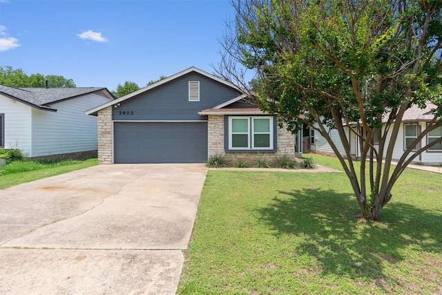 5902 Shreveport Dr, Austin, TX 78727 - view of front of home featuring an attached garage, a front lawn, driveway, and stone siding