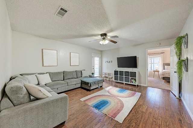 3310 Monument Dr, Round Rock, TX 78681 - living area with healthy amount of natural light, ceiling fan, a textured ceiling, and wood finished floors