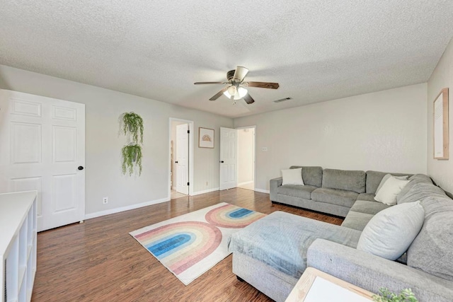 3310 Monument Dr, Round Rock, TX 78681 - living area featuring ceiling fan, wood finished floors, baseboards, and a textured ceiling