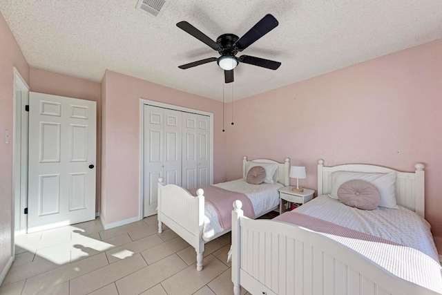 3310 Monument Dr, Round Rock, TX 78681 - bedroom featuring light tile patterned flooring, a closet, a ceiling fan, and a textured ceiling