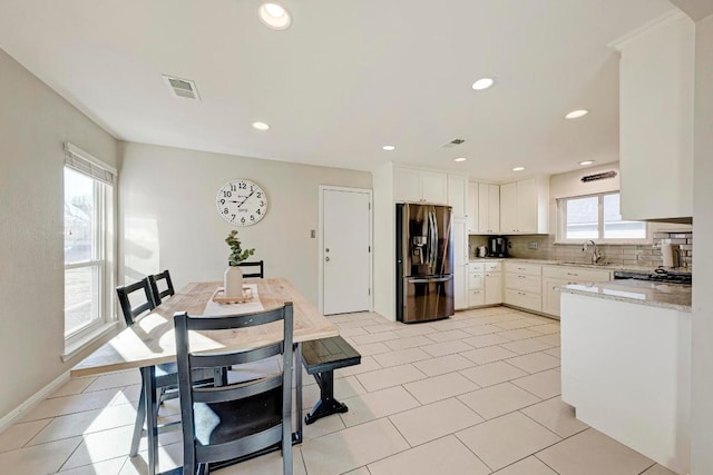 3310 Monument Dr, Round Rock, TX 78681 - kitchen featuring stainless steel fridge, a sink, tasteful backsplash, white cabinetry, and recessed lighting