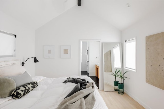 928 E 54th St, Austin, TX 78751 - bedroom with light wood finished floors, lofted ceiling, and ensuite bathroom
