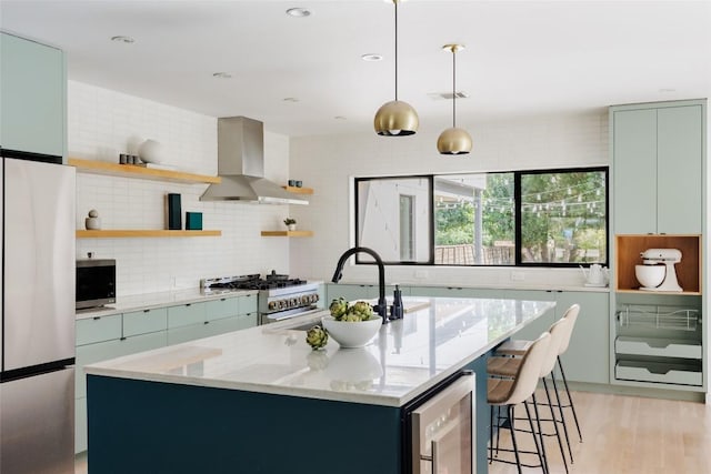 928 E 54th St, Austin, TX 78751 - kitchen featuring wall chimney range hood, stainless steel appliances, beverage cooler, open shelves, and decorative backsplash