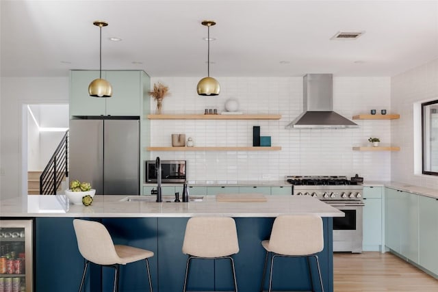 928 E 54th St, Austin, TX 78751 - kitchen with stainless steel appliances, wall chimney exhaust hood, open shelves, wine cooler, and decorative backsplash