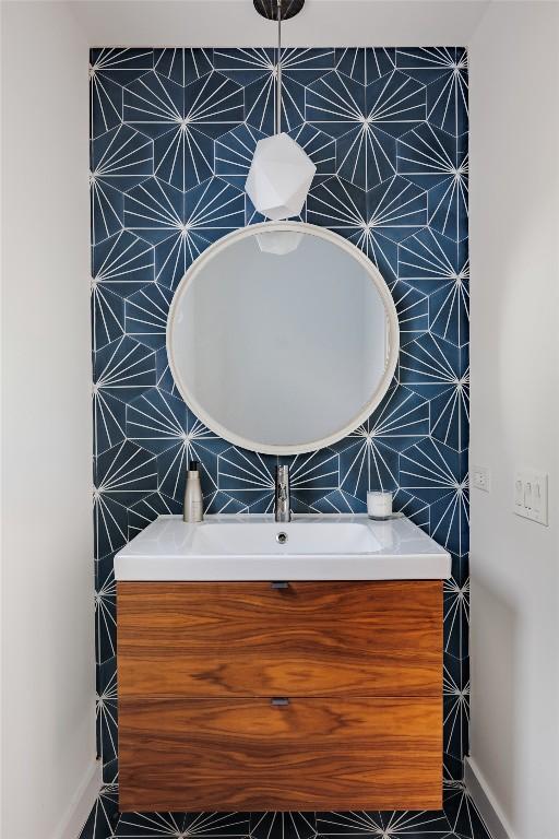 928 E 54th St, Austin, TX 78751 - half bathroom with backsplash, vanity, and tile walls