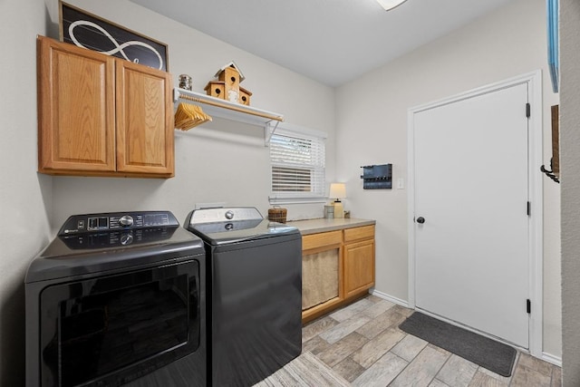 2003 Red Oak Cir, Round Rock, TX 78681 - laundry area featuring cabinet space, washer and clothes dryer, and light wood-style flooring