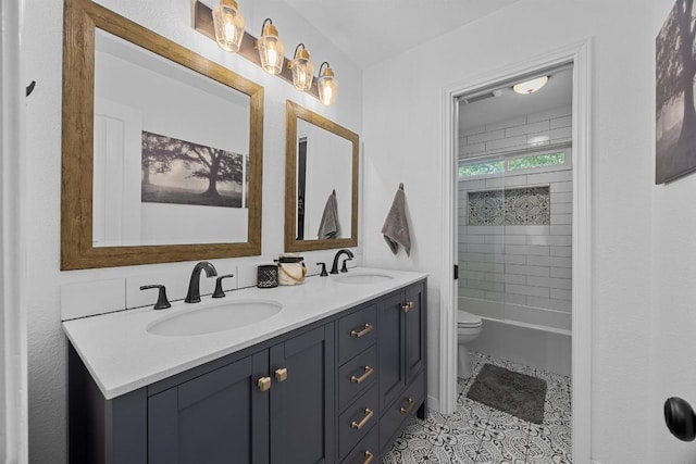 2003 Red Oak Cir, Round Rock, TX 78681 - bathroom featuring double vanity, toilet, tile patterned floors, and bathing tub / shower combination