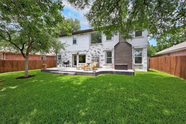 2003 Red Oak Cir, Round Rock, TX 78681 - rear view of house featuring a fenced backyard, a patio area, and stone siding