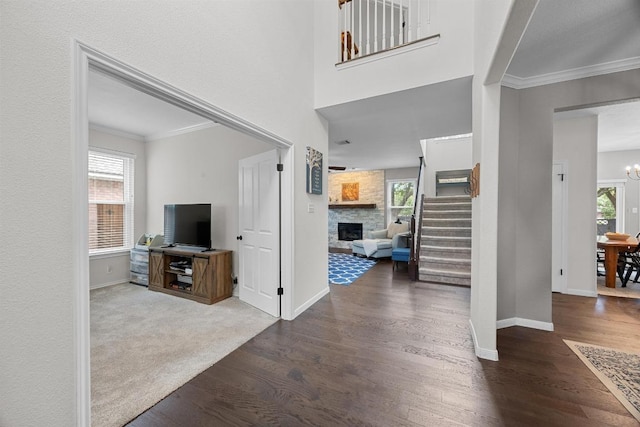 2003 Red Oak Cir, Round Rock, TX 78681 - foyer entrance featuring stairway, wood finished floors, baseboards, a fireplace, and crown molding