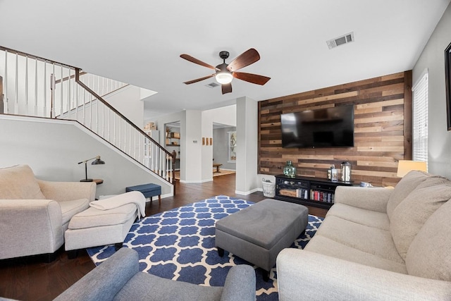 2003 Red Oak Cir, Round Rock, TX 78681 - living area with wooden walls, an accent wall, wood finished floors, stairs, and a ceiling fan