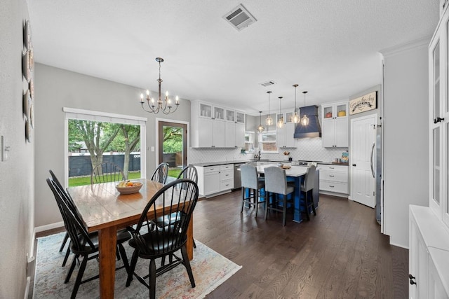 2003 Red Oak Cir, Round Rock, TX 78681 - dining space featuring a chandelier, dark wood-type flooring, and baseboards
