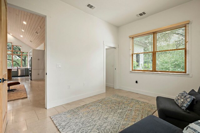 2819 Cross Rd, San Marcos, TX 78666 - sitting room featuring baseboards, lofted ceiling, light tile patterned floors, and recessed lighting