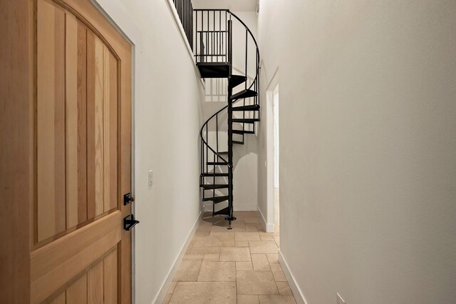 2819 Cross Rd, San Marcos, TX 78666 - entrance foyer featuring baseboards, stone tile flooring, stairs, and a high ceiling