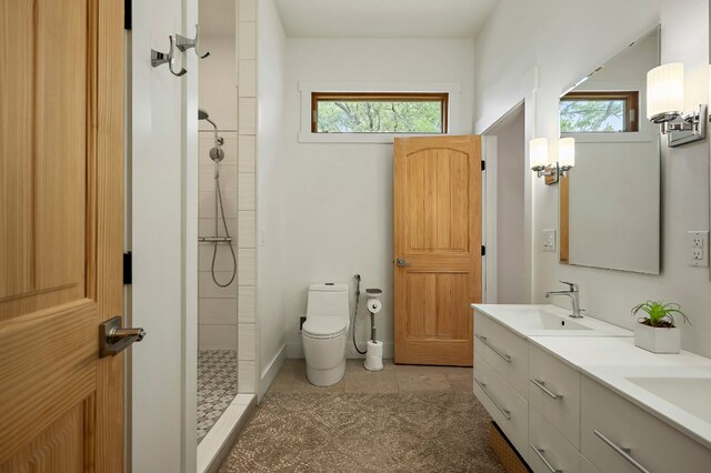 2819 Cross Rd, San Marcos, TX 78666 - bathroom with tiled shower, double vanity, toilet, and tile patterned floors