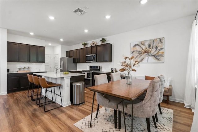 8103 Mandela Bnd, Austin, TX 78744 - dining space featuring recessed lighting, light wood finished floors, and baseboards