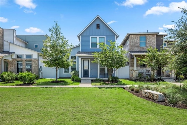 8103 Mandela Bnd, Austin, TX 78744 - view of front of property with board and batten siding, a front yard, and a porch