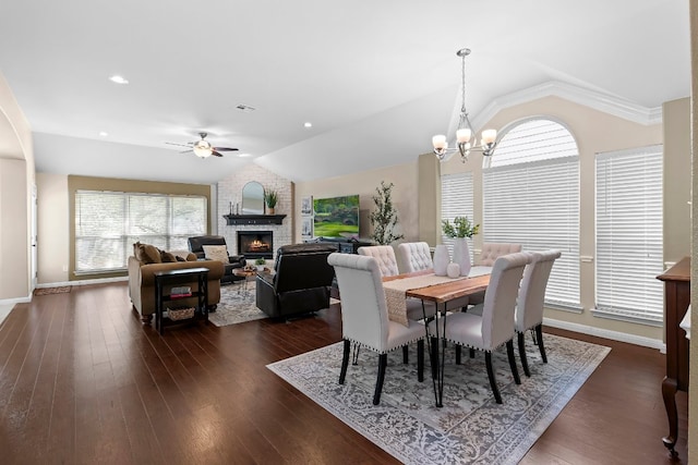 3712 Cerulean Way, Round Rock, TX 78681 - dining space with lofted ceiling, a fireplace, a ceiling fan, a chandelier, and dark wood-style floors