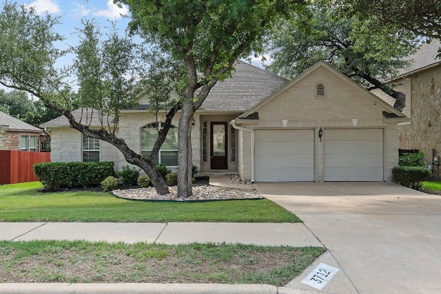 3712 Cerulean Way, Round Rock, TX 78681 - view of front facade with an attached garage, concrete driveway, stone siding, and a shingled roof