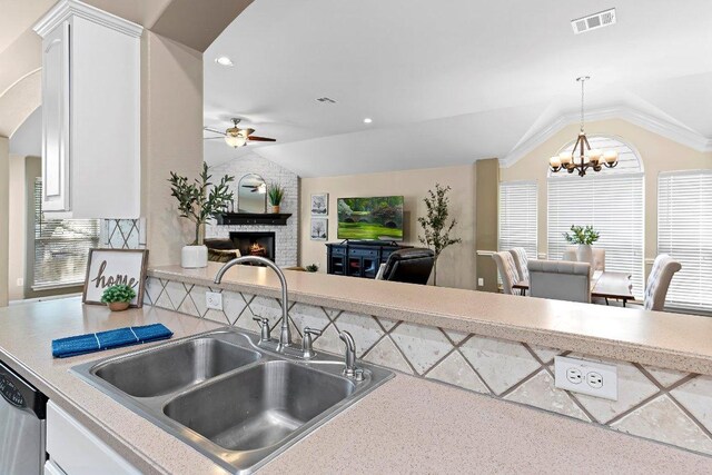 3712 Cerulean Way, Round Rock, TX 78681 - kitchen with lofted ceiling, ceiling fan, a fireplace, a chandelier, and light countertops