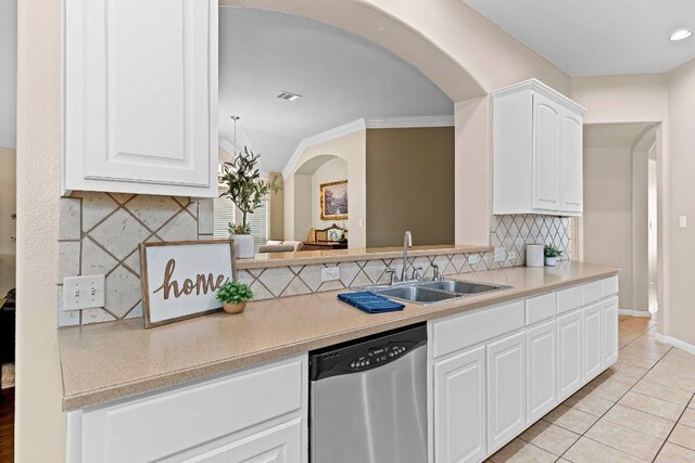 3712 Cerulean Way, Round Rock, TX 78681 - kitchen featuring stainless steel dishwasher, arched walkways, backsplash, light countertops, and light tile patterned floors