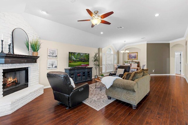 3712 Cerulean Way, Round Rock, TX 78681 - living area with lofted ceiling, a chandelier, a brick fireplace, a ceiling fan, and wood finished floors