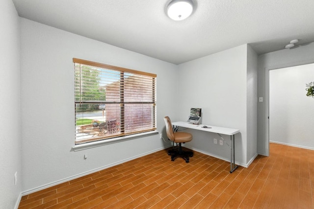 5504 Alomar Cv, Del Valle, TX 78617 - office area featuring wood finished floors and baseboards