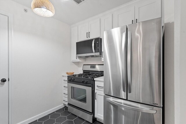 9525 N Capital Of Texas Hwy Unit 617, Austin, TX 78759 - kitchen with appliances with stainless steel finishes, light countertops, white cabinetry, dark tile patterned floors, and baseboards