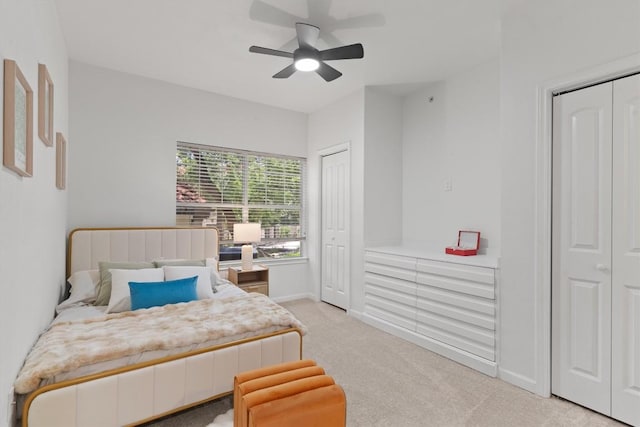 9525 N Capital Of Texas Hwy Unit 617, Austin, TX 78759 - bedroom featuring multiple closets, light carpet, and a ceiling fan