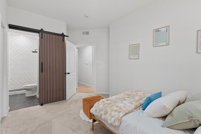 9525 N Capital Of Texas Hwy Unit 617, Austin, TX 78759 - bedroom featuring a barn door, ensuite bath, and carpet floors