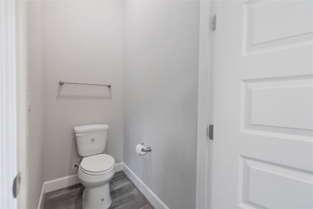 204 Hopping Peach St, San Marcos, TX 78666 - bathroom featuring wood finished floors, toilet, and baseboards