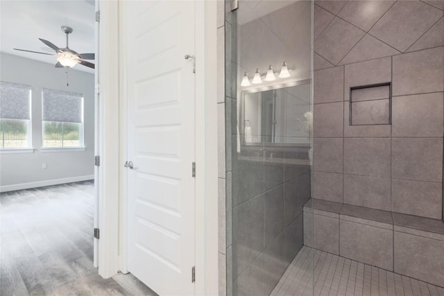 204 Hopping Peach St, San Marcos, TX 78666 - bathroom with a ceiling fan, tiled shower, wood finished floors, and baseboards