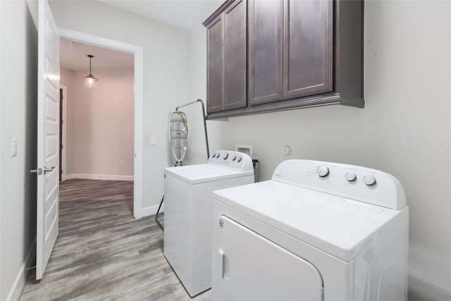 204 Hopping Peach St, San Marcos, TX 78666 - washroom with cabinet space, washer and clothes dryer, light wood finished floors, and baseboards