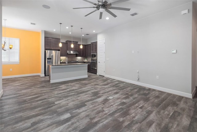 204 Hopping Peach St, San Marcos, TX 78666 - kitchen with open floor plan, appliances with stainless steel finishes, a ceiling fan, dark countertops, and recessed lighting