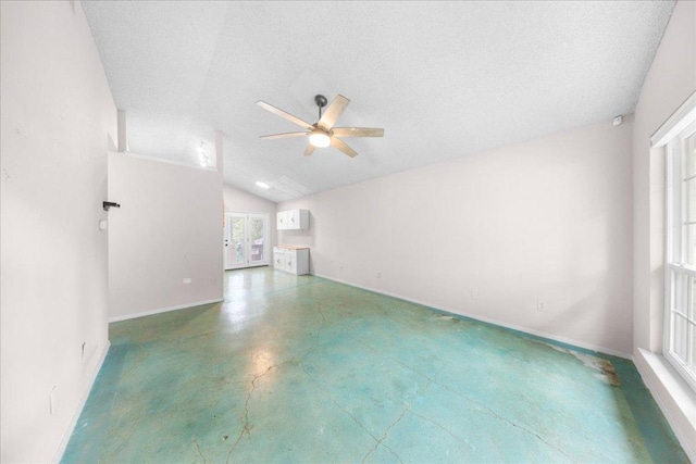 1015 E Yager Ln Unit 187, Austin, TX 78753 - unfurnished room with ceiling fan, baseboards, finished concrete flooring, french doors, and vaulted ceiling