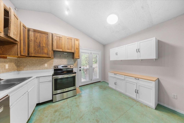 1015 E Yager Ln Unit 187, Austin, TX 78753 - kitchen with stainless steel appliances, vaulted ceiling, tasteful backsplash, light countertops, and a textured ceiling