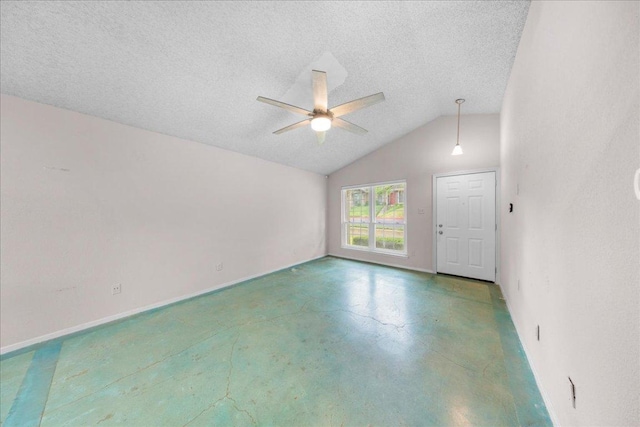 1015 E Yager Ln Unit 187, Austin, TX 78753 - spare room featuring finished concrete flooring, ceiling fan, vaulted ceiling, a textured ceiling, and baseboards