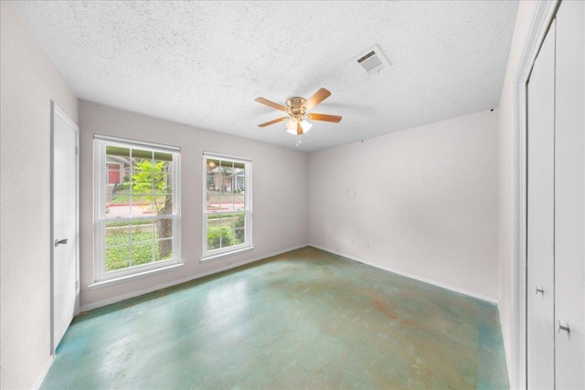 1015 E Yager Ln Unit 187, Austin, TX 78753 - spare room featuring finished concrete flooring, a ceiling fan, a textured ceiling, and baseboards