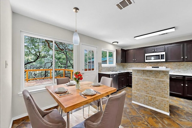 1115 Byers Ln, Austin, TX 78753 - dining area featuring plenty of natural light and dark stone finish flooring